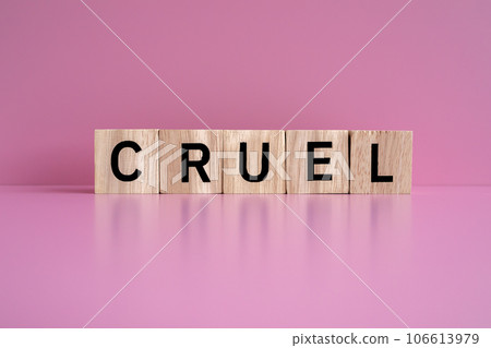 Wooden blocks form the text "CRUEL" against a pink background. Wooden blocks form the text "CRUEL" against a pink background. 106613979