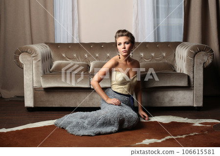 Fashion portrait of attractive brunette woman in fashionable evening gown resting Fashion portrait of attractive brunette woman in fashionable evening gown resting 106615581