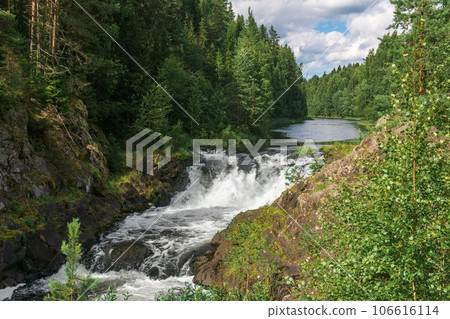 natural landscape with a clear waterfall on a forest water 106616114