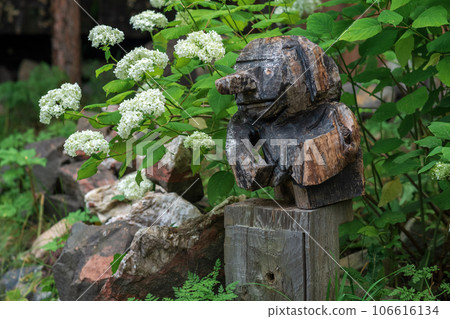 funny wooden garden figurine, carelessly carved 106616134