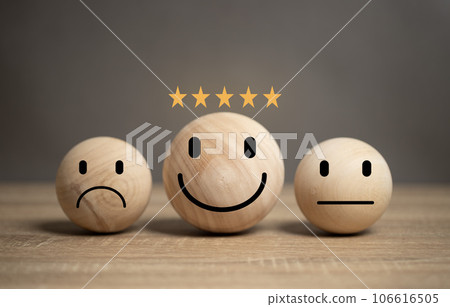 Concepts satisfaction. The wooden ball has smiling and frowning faces to express happy and unhappy emotions. There is a star showing the highest satisfaction score. Concepts satisfaction. The wooden ball has smiling and frowning faces to express happy and unhappy emotions. There is a star showing the highest satisfaction score. 106616505