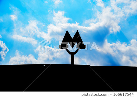 A subway sign against the sky  106617544