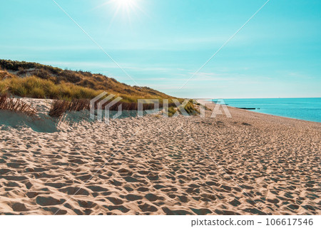 Beach landscape with a bright sun on the Sylt island in North Sea Beach landscape with a bright sun on the Sylt island in North Sea 106617546