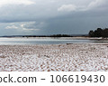 Snow on a sandy beach, undulating sand, summer. Disturbance of the earth's climate, ecological disaster 106619430