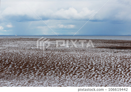 Snow on a sandy beach, undulating sand, summer. Disturbance of the earth's climate, ecological disaster 106619442