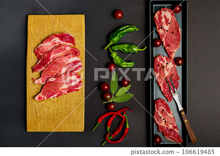 pork meat and vegetables on black background 106619485