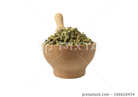 Dried leaves o Lemon verbena in latin Aloysia citrodora in wooden bowl and scoop isolated on white background. Medicinal herb. Dried leaves o Lemon verbena in latin Aloysia citrodora in wooden bowl and scoop isolated on white background. Medicinal herb. 106620454