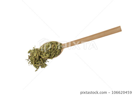 Dried leaves o Lemon verbena in latin Aloysia citrodora on wooden spoon isolated on white background. Medicinal. herb. 106620459