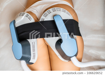Young woman undergoes buttock contouring using specialized body sculpting equipment 106620652
