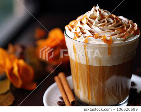 Still life of Delicious pumpkin spice latte cappuccino coffee with whipped cream and caramel in mug. 106620699