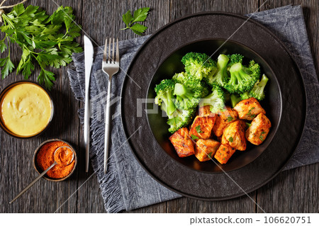 baked salmon bites with steamed broccoli florets 106620751