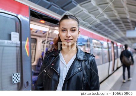 Teenage girl on platform of subway station 106620905
