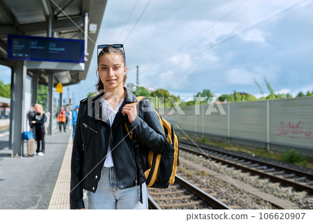 Young female waiting for an electric train at city railway station 106620907