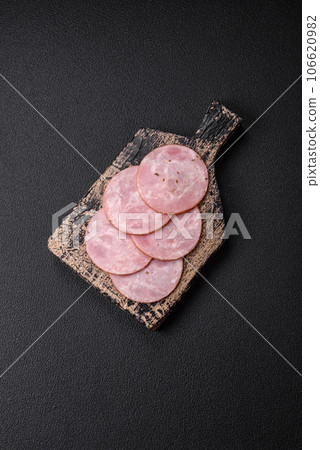 Delicious fresh ham cut into round slices with salt, spices and herbs Delicious fresh ham cut into round slices with salt, spices and herbs 106620982