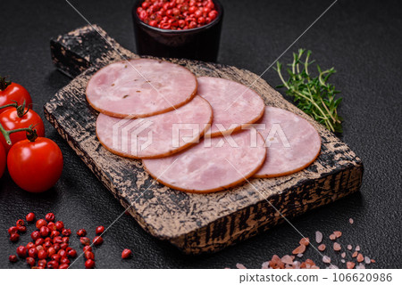 Delicious fresh ham cut into round slices with salt, spices and herbs Delicious fresh ham cut into round slices with salt, spices and herbs 106620986