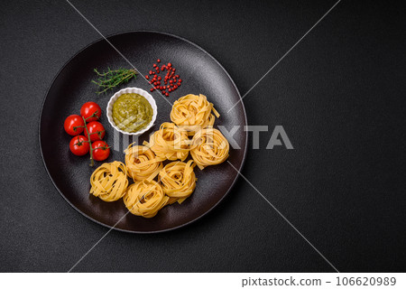 Delicious fresh pasta consisting pesto sauce with salt, spices and herbs Delicious fresh pasta consisting pesto sauce with salt, spices and herbs 106620989