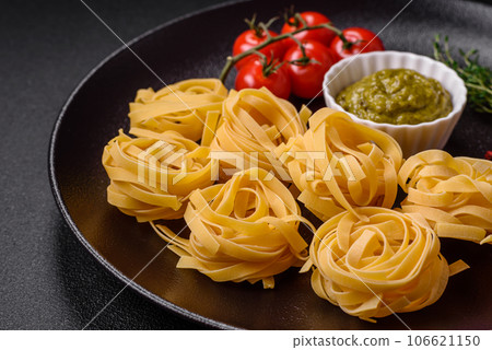 Delicious fresh pasta consisting pesto sauce with salt, spices and herbs Delicious fresh pasta consisting pesto sauce with salt, spices and herbs 106621150