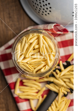Fusilli pugliesi. Italian twisted pasta in jar. Top view. 106621203