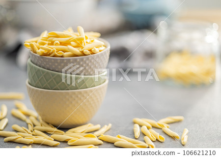 Fusilli pugliesi. Italian twisted pasta in bowl on gray table. 106621210