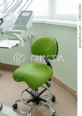 Modern dental office. Dentist's tools for dental treatment. The workplace of the dentist in the clinic. Dentist's green chair Modern dental office. Dentist's tools for dental treatment. The workplace of the dentist in the clinic. Dentist's green chair 106621361