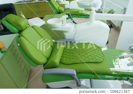 Modern dental office in green. Dental unit with dental instruments. Autoclave Modern dental office in green. Dental unit with dental instruments. Autoclave 106621367