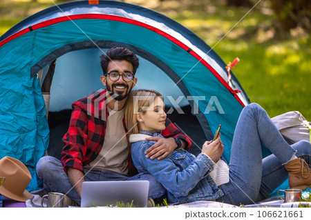 Young couple spending time in nature in the forest and looking relaxed and happy 106621661