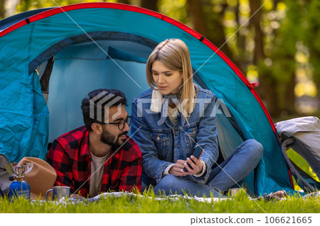Young couple spending time in nature in the forest and looking relaxed and happy 106621665