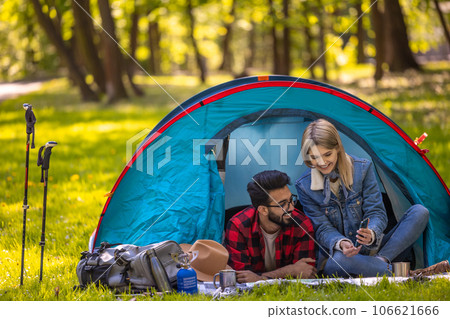 Young couple spending time in nature in the forest and looking relaxed and happy 106621666