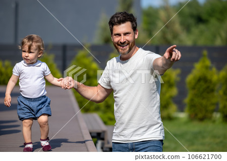 Happy young father and his little son on the walk 106621700