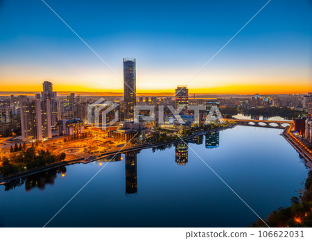 Yekaterinburg city and pond aerial panoramic view at summer or early autumn night. Night city in the early autumn or summer. Yekaterinburg city and pond aerial panoramic view at summer or early autumn night. Night city in the early autumn or summer. 106622031