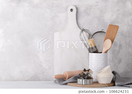Kitchen shelf with white modern ceramic and wooden dishware Kitchen shelf with white modern ceramic and wooden dishware 106624231