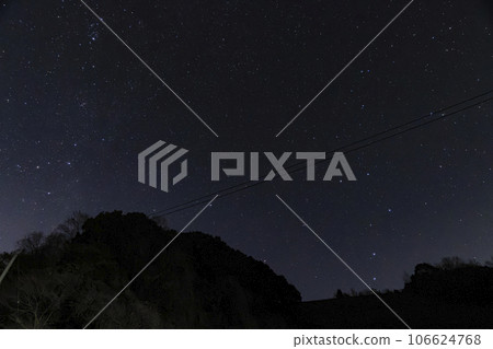 A winter starscape, the rising Big Dipper, the setting Cassiopeia constellation 106624768