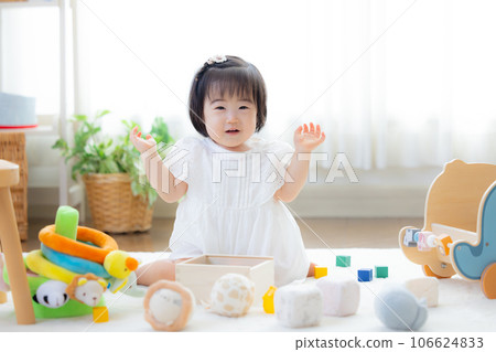 Family girl playing with building blocks Family girl playing with building blocks 106624833