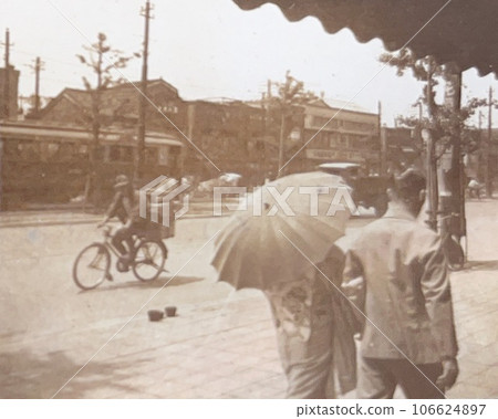 A woman in a kimono walking with a parasol, 1930s Tokyo cityscape A woman in a kimono walking with a parasol, 1930s Tokyo cityscape 106624897