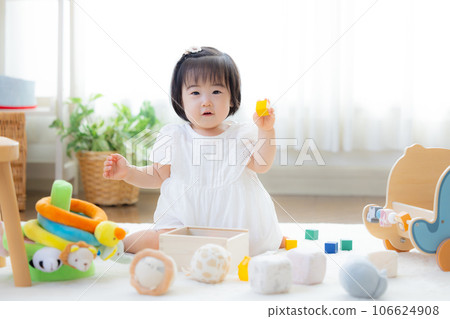Family girl playing with building blocks Family girl playing with building blocks 106624908