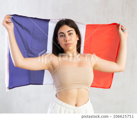 Young woman with flag of France posing in studio 106625751