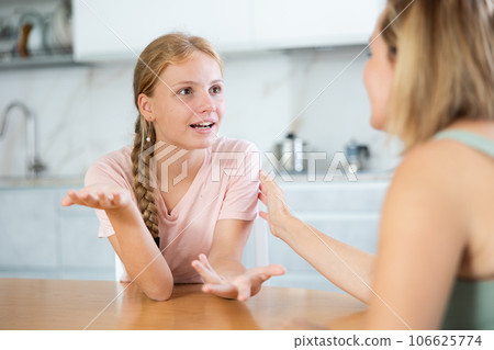 Teenage daughter enthusiastically tells unrecognizable mother about planned vacation with friends 106625774