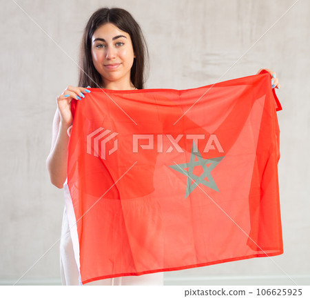 Happy young woman with flag of Monaco against unicoloured background Happy young woman with flag of Monaco against unicoloured background 106625925