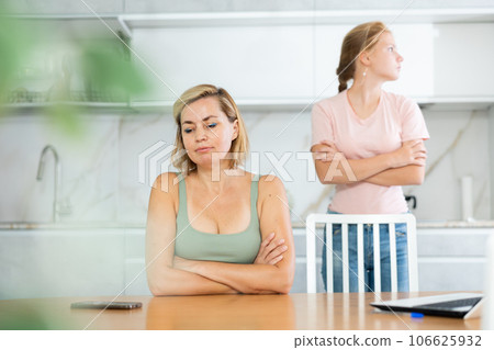 Quarreled mum and daughter do not talk ignore to each other and look in different directions. 106625932