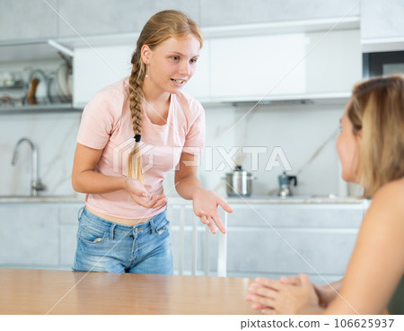 Teenage daughter enthusiastically tells unrecognizable mother about planned vacation with friends Teenage daughter enthusiastically tells unrecognizable mother about planned vacation with friends 106625937