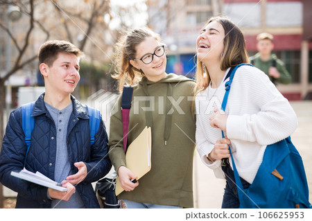 Teenage students talking outside after lessons 106625953
