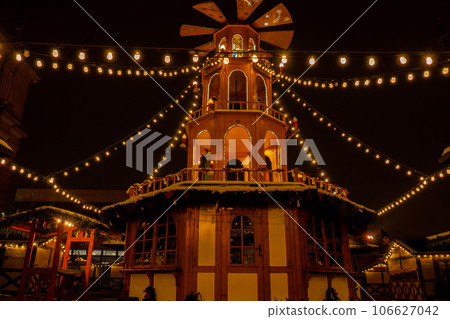 Holiday decorations of Coal Market - Targ Weglowy square in Gdansk Poland. Beautiful Christmas fair in the old town at night. Advent winter time in Europe background. Markets in December Ornamented Holiday decorations of Coal Market - Targ Weglowy square in Gdansk Poland. Beautiful Christmas fair in the old town at night. Advent winter time in Europe background. Markets in December Ornamented 106627042