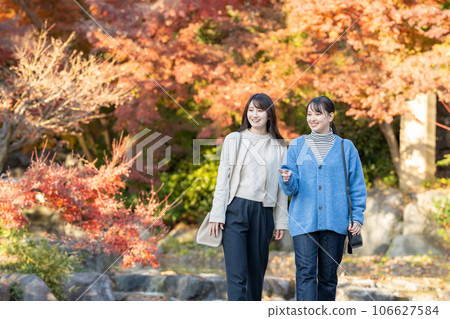 A woman enjoying autumn leaves 106627584