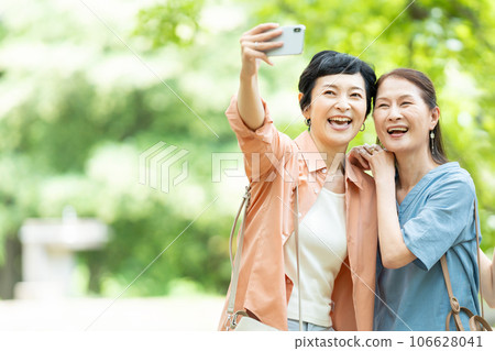 Smiling senior woman with camera Smiling senior woman with camera 106628041