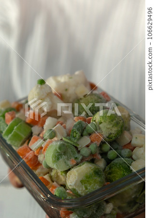 Unrecognizable woman showing Frozen mixed vegetables homemade. Harvesting concept. Stocking up vegetables for winter storage 106629496