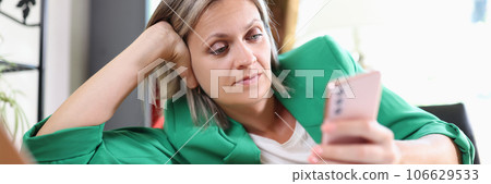 Woman surfing internet on smartphone in office Woman surfing internet on smartphone in office 106629533