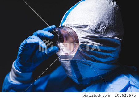 Men in protective clothing for infectious disease control Men in protective clothing for infectious disease control 106629679
