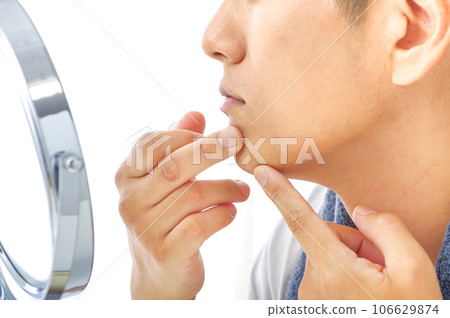 A man in his 40s who is concerned about his skin condition A man in his 40s who is concerned about his skin condition 106629874