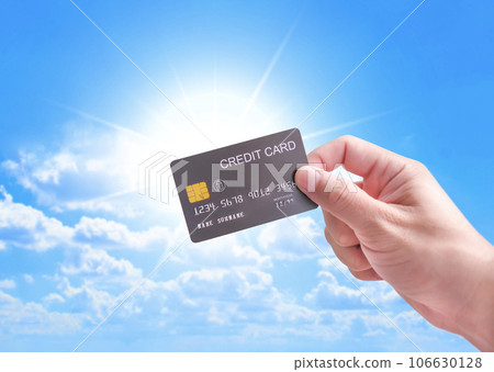 Credit cards concept, hand holding luxury credit card with sunlight and blue sky background Credit cards concept, hand holding luxury credit card with sunlight and blue sky background 106630128