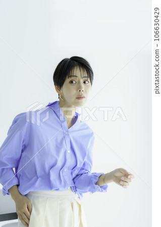 Fashion portrait of a young woman on a white background vertical position 106630429